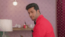 a man wearing a red jacket and black bow tie