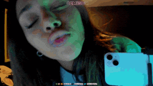a woman is taking a picture of herself with her eyes closed and the words dtmisk on the bottom right corner