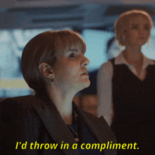 a woman says " i 'd throw in a compliment " while another woman stands behind her
