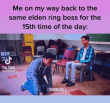a man is kneeling down in front of a man sitting in a chair in a classroom .