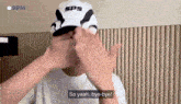 a man wearing a sps hat is saying so yeah bye-bye