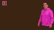 a man in a pink sweatshirt points to the word brown