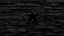 the letter a is glowing in the dark against a dark brick wall