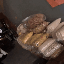 a bunch of bags of food are stacked on top of each other on a counter