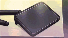 a tablet is sitting on a desk next to a pen