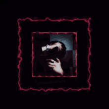 a picture of a person covering their face with their hands in a dark room