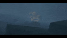 a statue of a woman stands in the fog