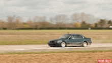 a green car is driving down a road with the words thinkjules on the bottom right