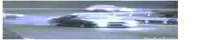 a blurred image of a car driving down a road with the letters r on it