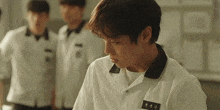 a young man in a white shirt has a name tag that says ' eun ' on it