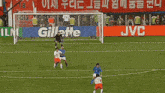 a soccer game is being played in front of a banner that says corea