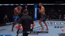 two men are fighting in a boxing ring with a bud light banner on the side