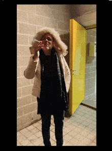 a man in a fur coat smoking a cigarette