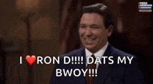 a man in a suit and tie says that he loves ron d.