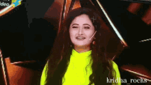 a woman in a neon green sweater is smiling and has the name krishna_rocks on the bottom right