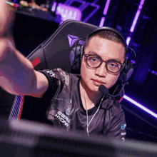 a man wearing headphones and a shirt that says htcw