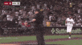 a baseball game is being played and the score is 5 to 6