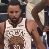 a basketball player wearing a jersey that says the town