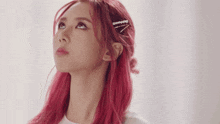 a woman with red hair is looking up at something