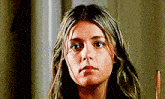 a close up of a woman 's face looking at the camera .