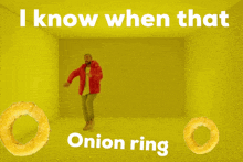 a man in a red jacket is dancing with onion rings in front of him and the words i know when that onion ring