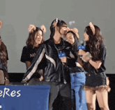 a group of people standing in front of a blue box that says eres