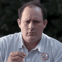 a man wearing a shirt with a no marijuana sign on it