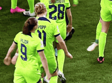 a group of soccer players are standing on a field .