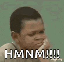 a young boy is making a funny face and saying `` hmm ! ''