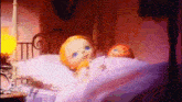 two dolls are laying in a bed in a room