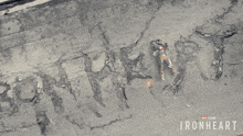 an aerial view of a person laying on the ground with the word ironheart written on the ground