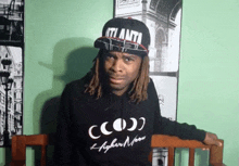 a man wearing an atlanta hat and a higher moon sweatshirt