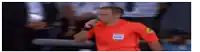 a referee is talking on a cell phone during a soccer match .