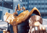 a superhero is wearing a helmet and a glove with the word crew on it .