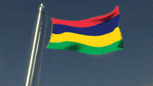 the flag of mauritius is waving in the wind against a blue sky