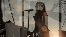 a woman singing into a microphone with a name tag that says a