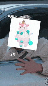 a man in a car holds a picture of a unicorn in front of his face with 55 burgers written below it