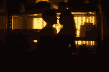 a man and woman are kissing in a dark room