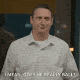 a man in a plaid shirt is smiling and asking , `` i mean , does he really ball ? ``