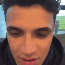 a close up of a man 's face with a blurred background