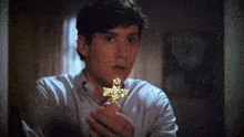 Holding A Cross Charley Brewster GIF - Holding A Cross Charley Brewster Fright Night GIFs