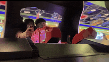 a girl playing a video game with a sign that says unanswerable in the background
