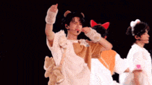 a man wearing a cat costume is giving a thumbs up sign