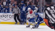 a hockey game is being played in front of a sign that says ' jackpot city casino '