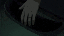 a person is standing in a dark room holding a black object .