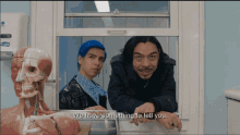 two men looking out of a window with the words we have something to tell you