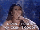 a woman is singing into a microphone and saying `` damn ... publix , chicken is good ! ''