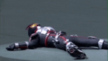a person in a superhero costume is laying on the floor .