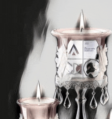 a drawing of two candles with the letters a and c in the background