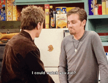 two men are standing next to each other and one of them is asking the other if he could watch you eat